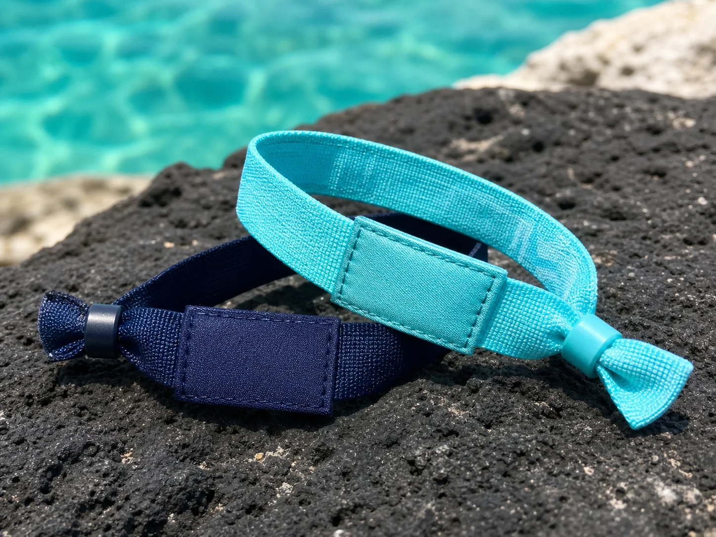 Macro view of aqua and navy woven wristbands with stitched module pockets
